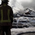 Winter weather firefighters assess building damage after the fire is extinguished