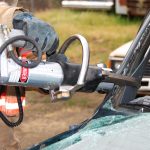 Rescue worker uses hydraulic cutter on wrecked vehicle fire apparatus jon's mid-america